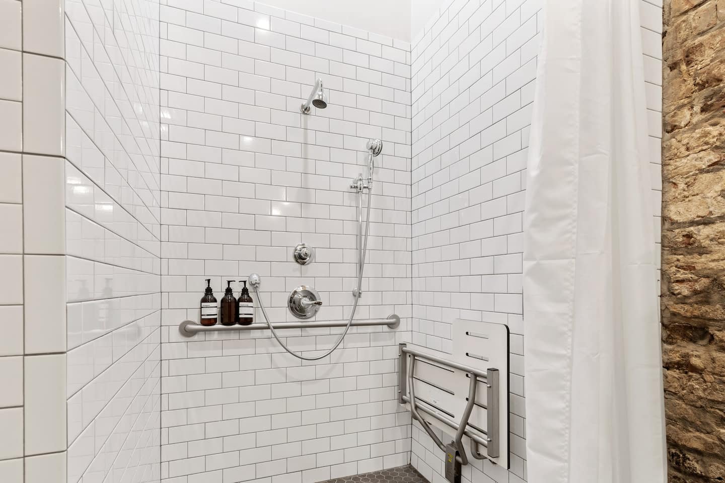 Walk-in, ADA compliant shower in ensuite bathroom attached to bedroom 2
