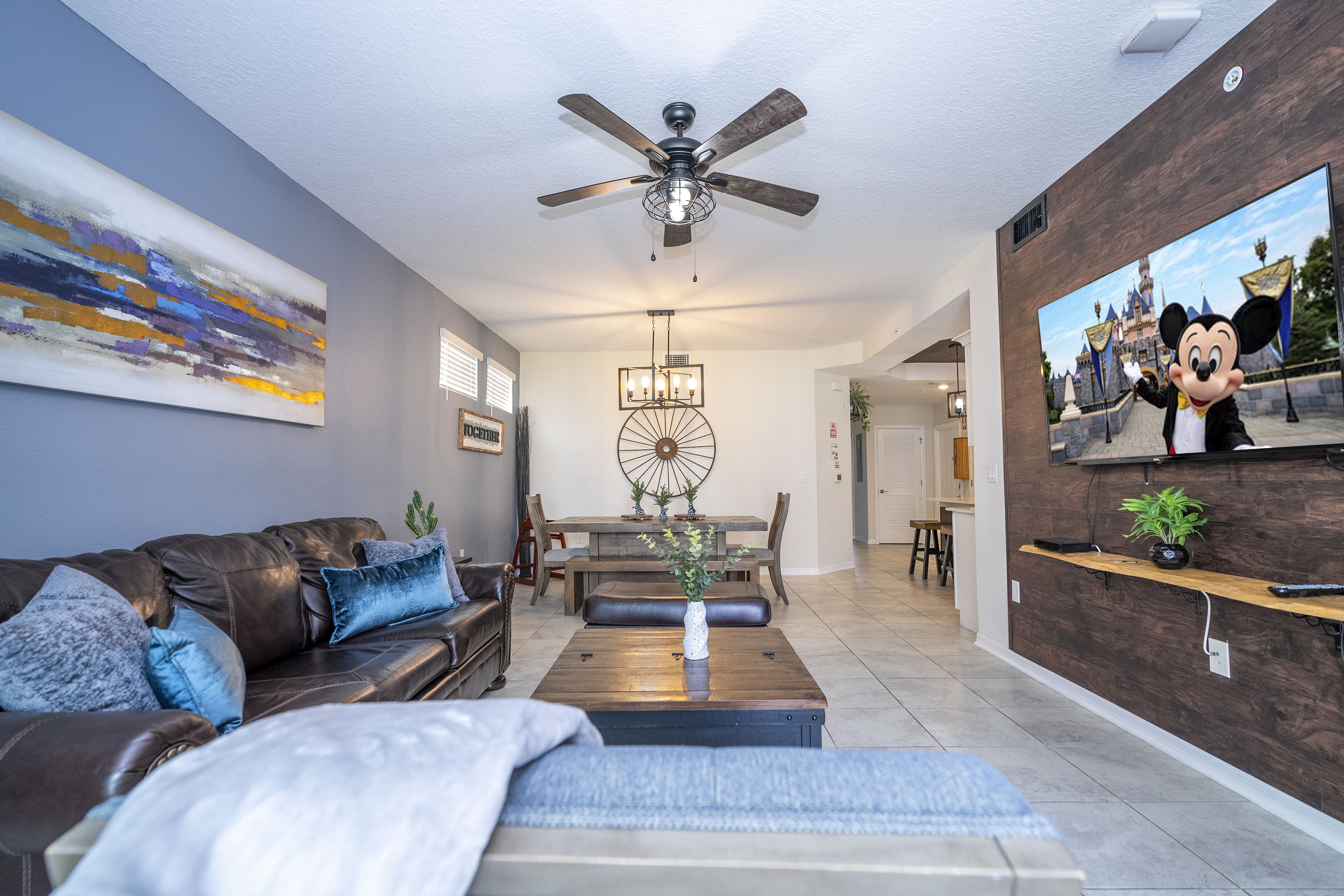 Step into this spacious, comfortable living area. The expansive room is adorned with tasteful decor, offering a blend of modern aesthetics and homey warmth. 