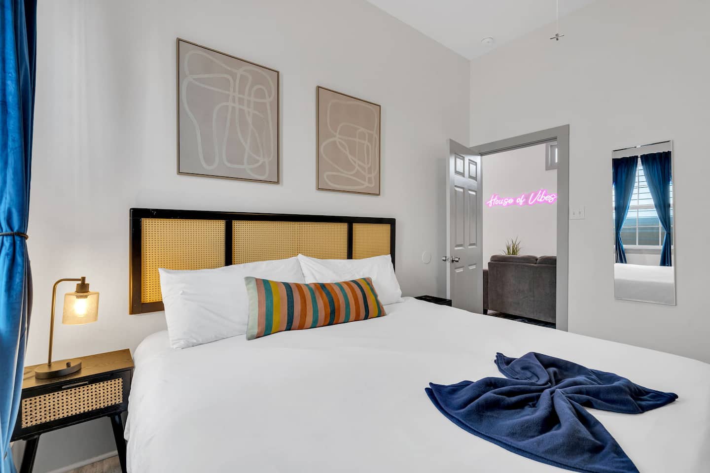 Unwind in this stylish bedroom featuring a plush king-size bed, luxe linens, and a modern boho-inspired design. Soft lighting, bold accents, and a warm ambiance make this the perfect space to relax and recharge.