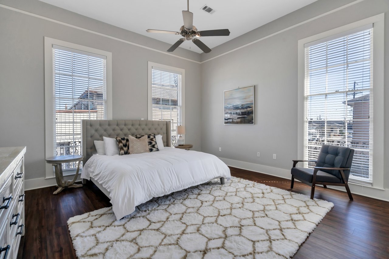 Spacious primary suite with natural light and elegant New Orleans style.