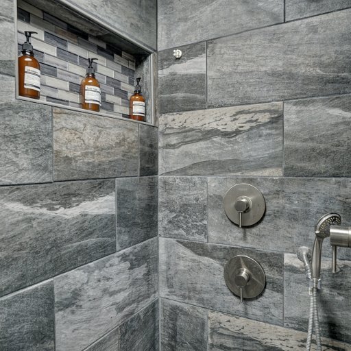 Private primary bath with elevated finishes and spa-inspired shower.