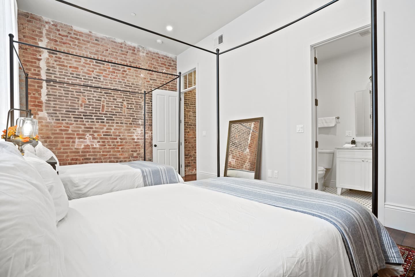 Master bedroom space with en suite bathroom | Two queen beds