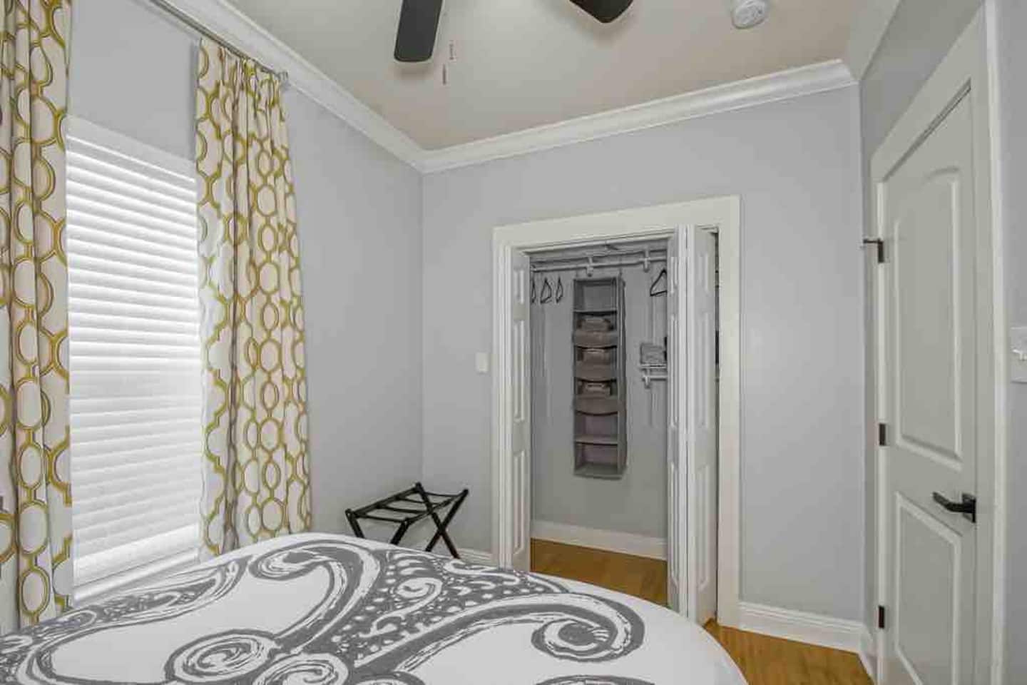 Guest room with smart tv, closet organization and luggage stands