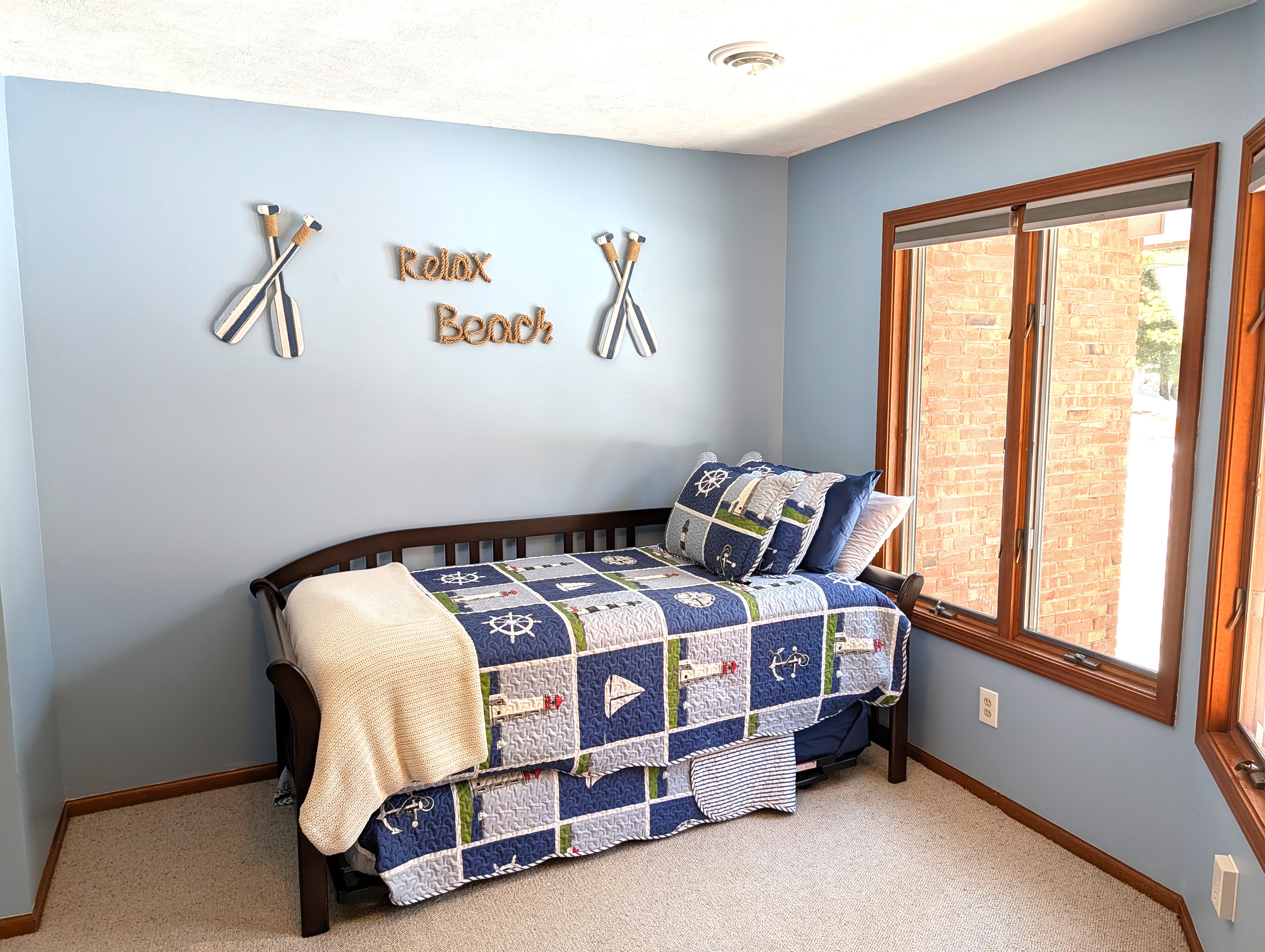 BEDROOM #1 (FIRST FLOOR):  There is a small bedroom with a trundle bed on the first floor.  Includes a closet, dresser, and mirror as well.