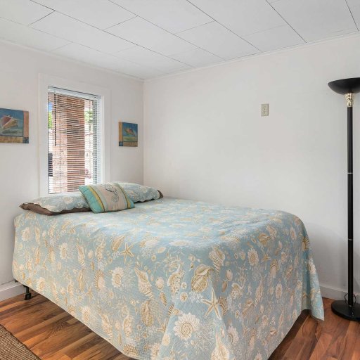 Rest easy in the queen bed — quiet, cozy, and naturally lit by the cabin’s wooded surroundings.