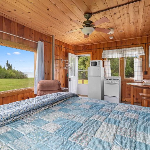 Open-concept studio layout with natural wood finishes and lake-area charm.