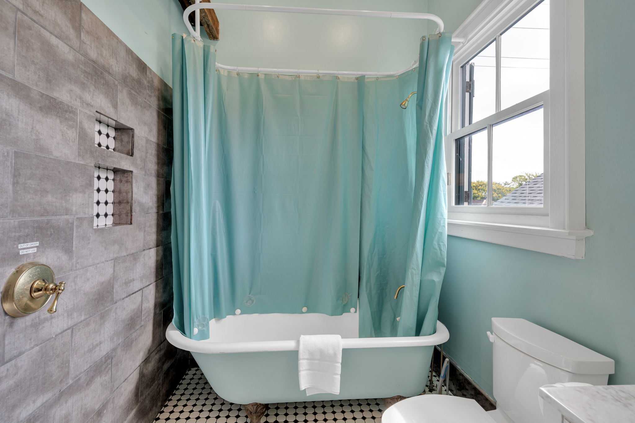 Classic clawfoot tub and soothing blue tones for unwinding