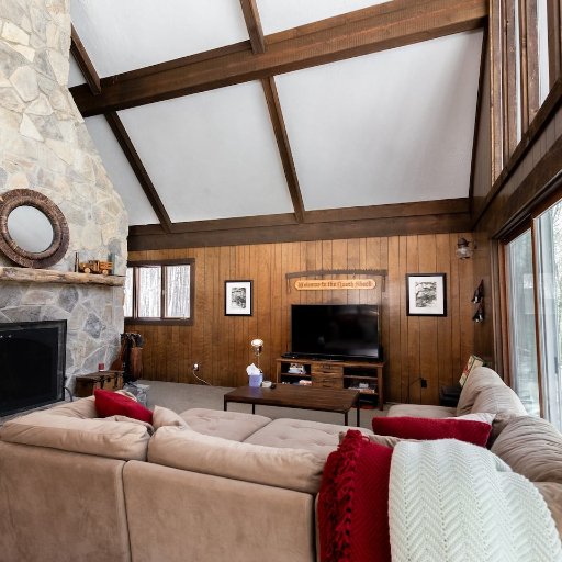 Enjoy movie nights by the stone fireplace in this warm and welcoming living room—ideal for all seasons!