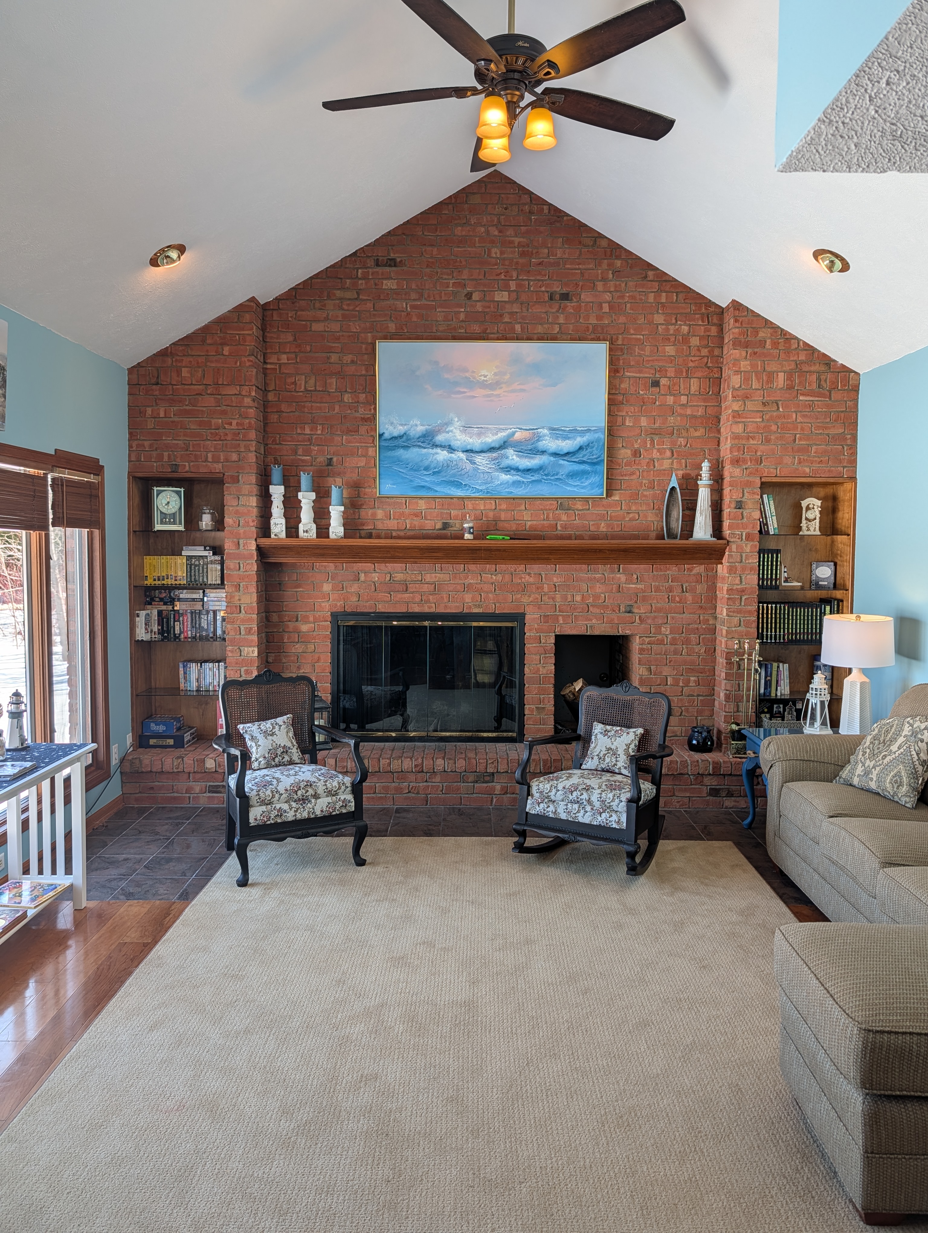LIVING ROOM #1:  The primary living room, which has a great view of Big Platte Lake!  (Note that the wood fireplace in the photo is available for guest usage.)