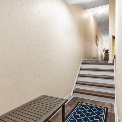 Stairs from the private entrance up to the living floor.