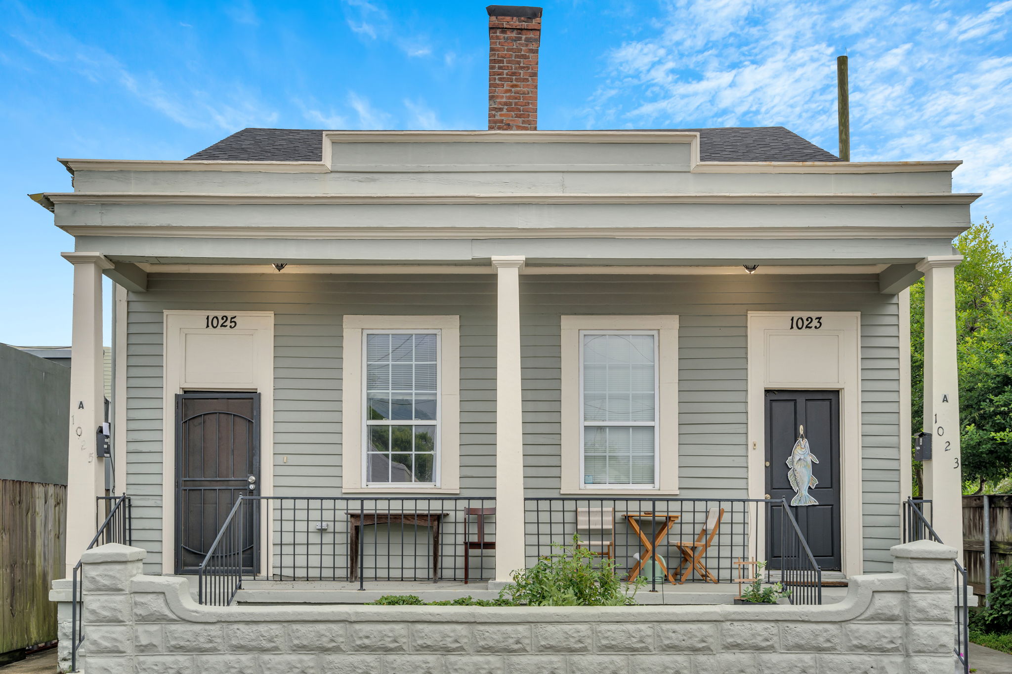 Charming New Orleans double with classic front porch seating.