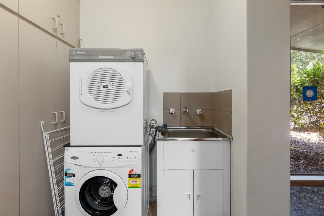 Secondary bathroom is steps from the rear door – ideal for rinsing off sand after beach visits before re-entering the apartment.