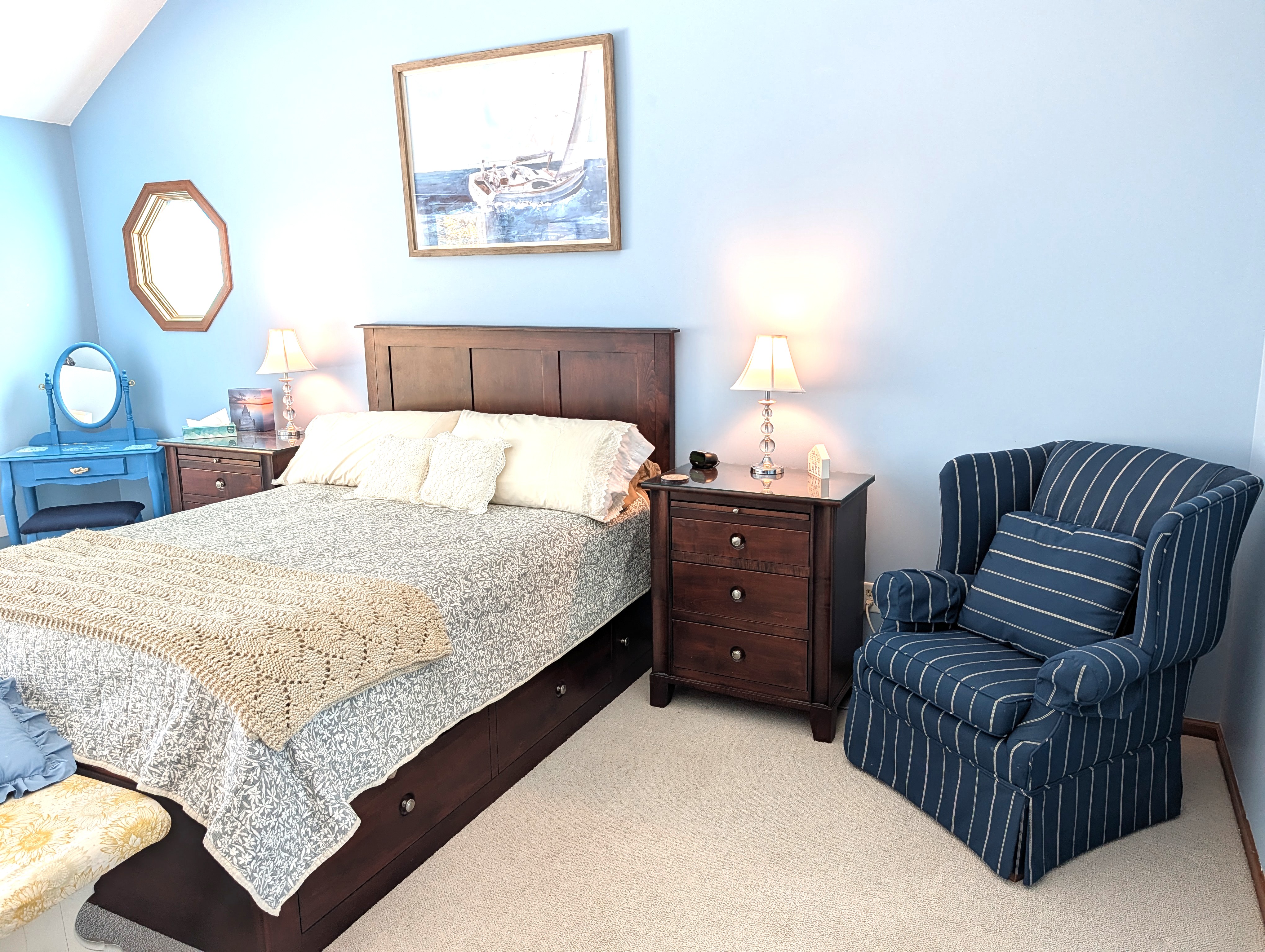 BEDROOM #2 (SECOND FLOOR):  The home has a huge primary bedroom on the second floor with a queen-size bed, private ensuite bathroom, and great views of Big Platte Lake!