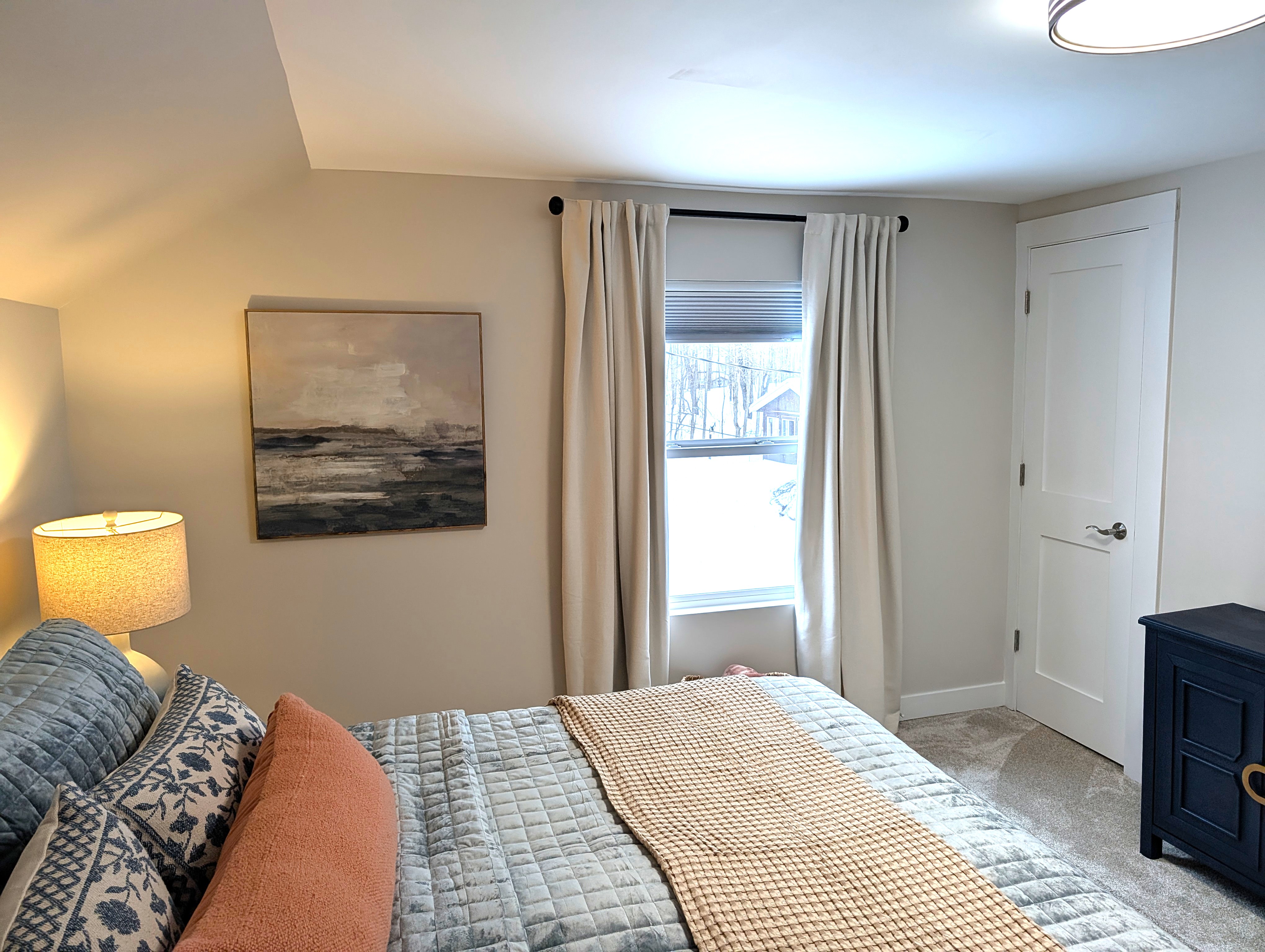 BEDROOM #2 (SECOND FLOOR):  Beautiful newly-decorated second floor bedroom with a king-size bed, private television, nightstands, lamps, dresser, and closet.