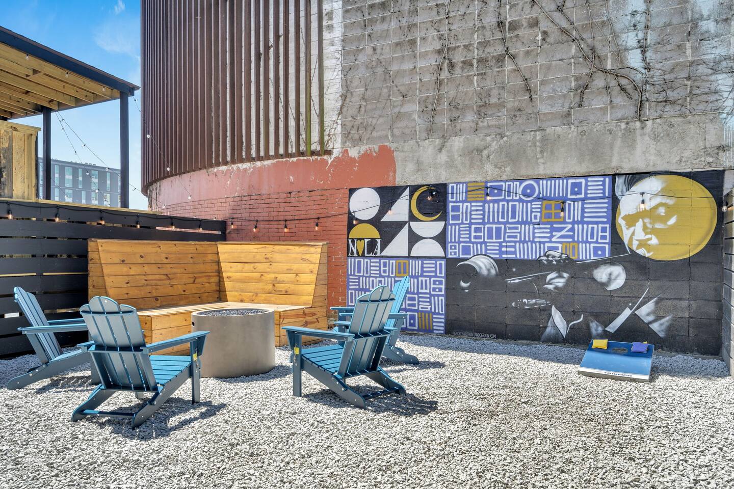 Stylish city patio with fire pit, local art, and laid-back vibes.