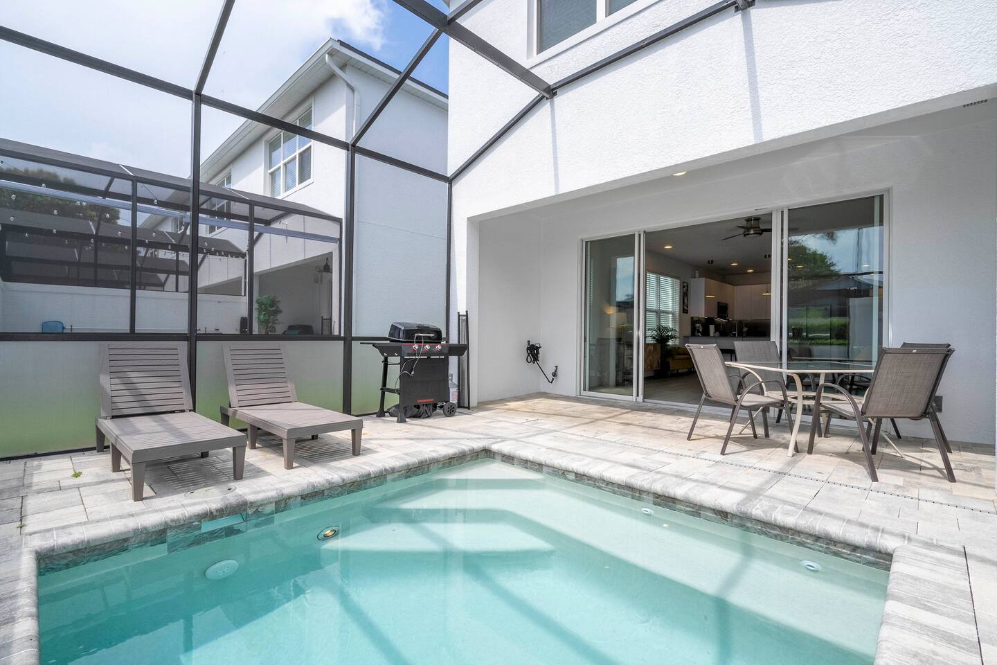 Enjoy a spacious screened patio featuring a private pool and jacuzzi, perfect for relaxation and fun. Comfortable outdoor furniture, ideal for lounging, dining, or soaking up the sun in a serene setting. Whether you're taking a refreshing swim, enjoying a soak in the warm jacuzzi, or simply unwinding with a drink in hand, this outdoor  offers the perfect blend of comfort and tranquility.