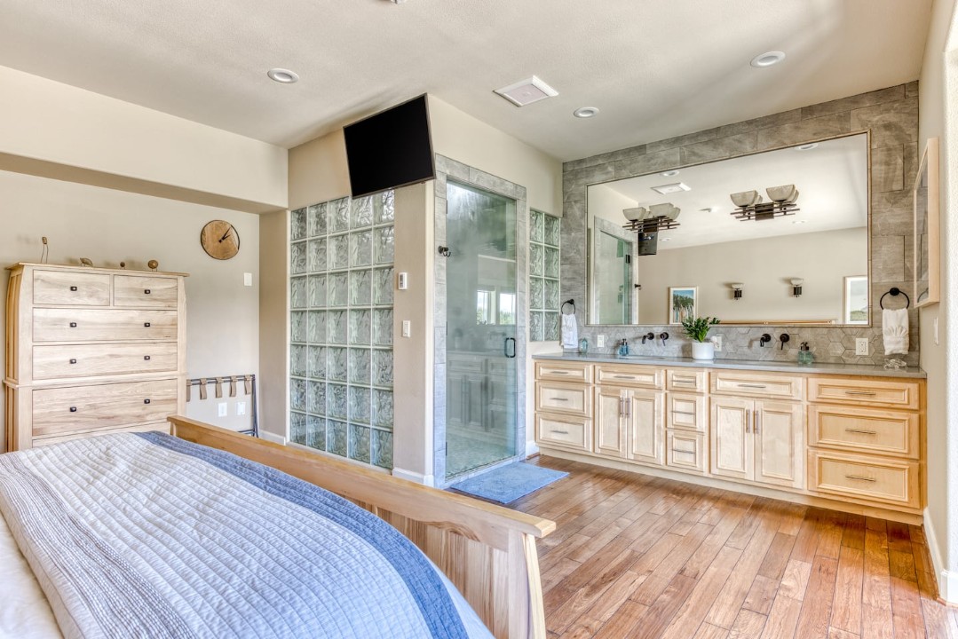The downstairs master bathroom is open, spacious, and incorporated into ...