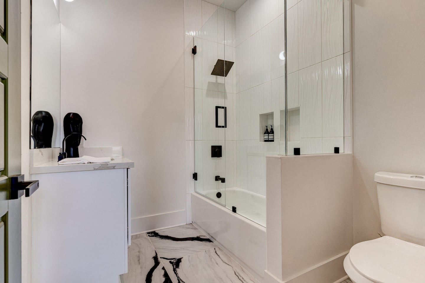 Luxe master bathroom with glass enclosure and rainfall shower head. (Bathroom 1.5/3.5)