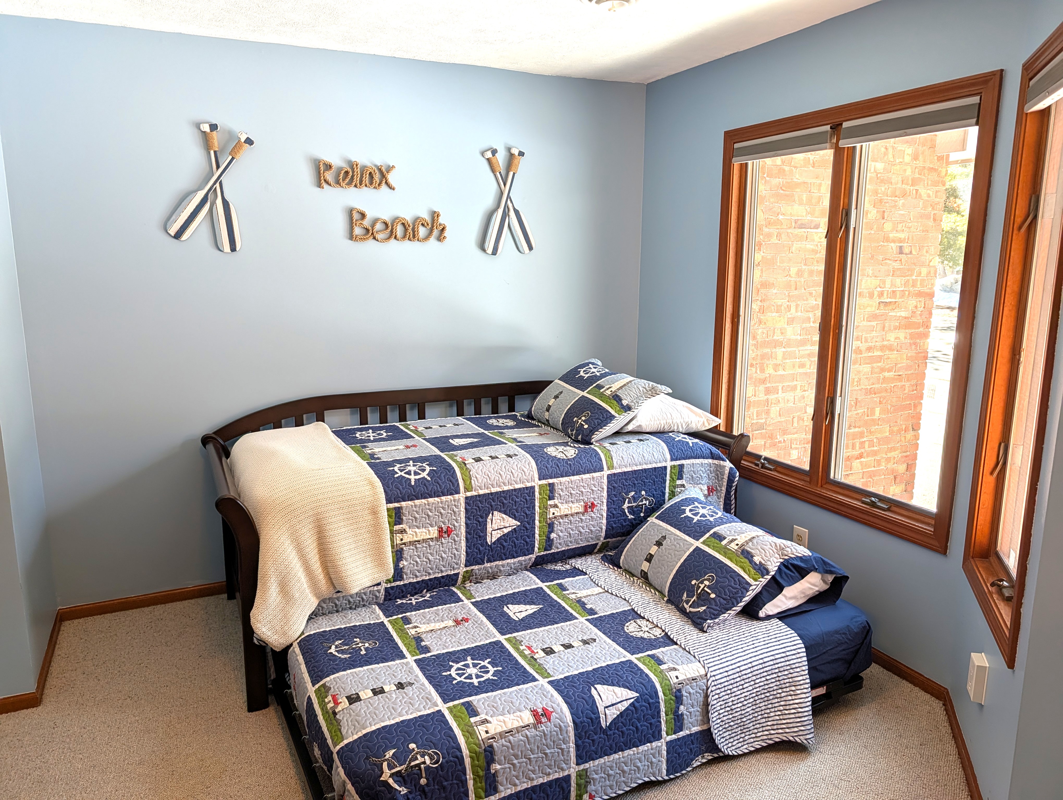 BEDROOM #1 (FIRST FLOOR):  There is a small bedroom with a trundle bed on the first floor.  Includes a closet, dresser, and mirror as well.