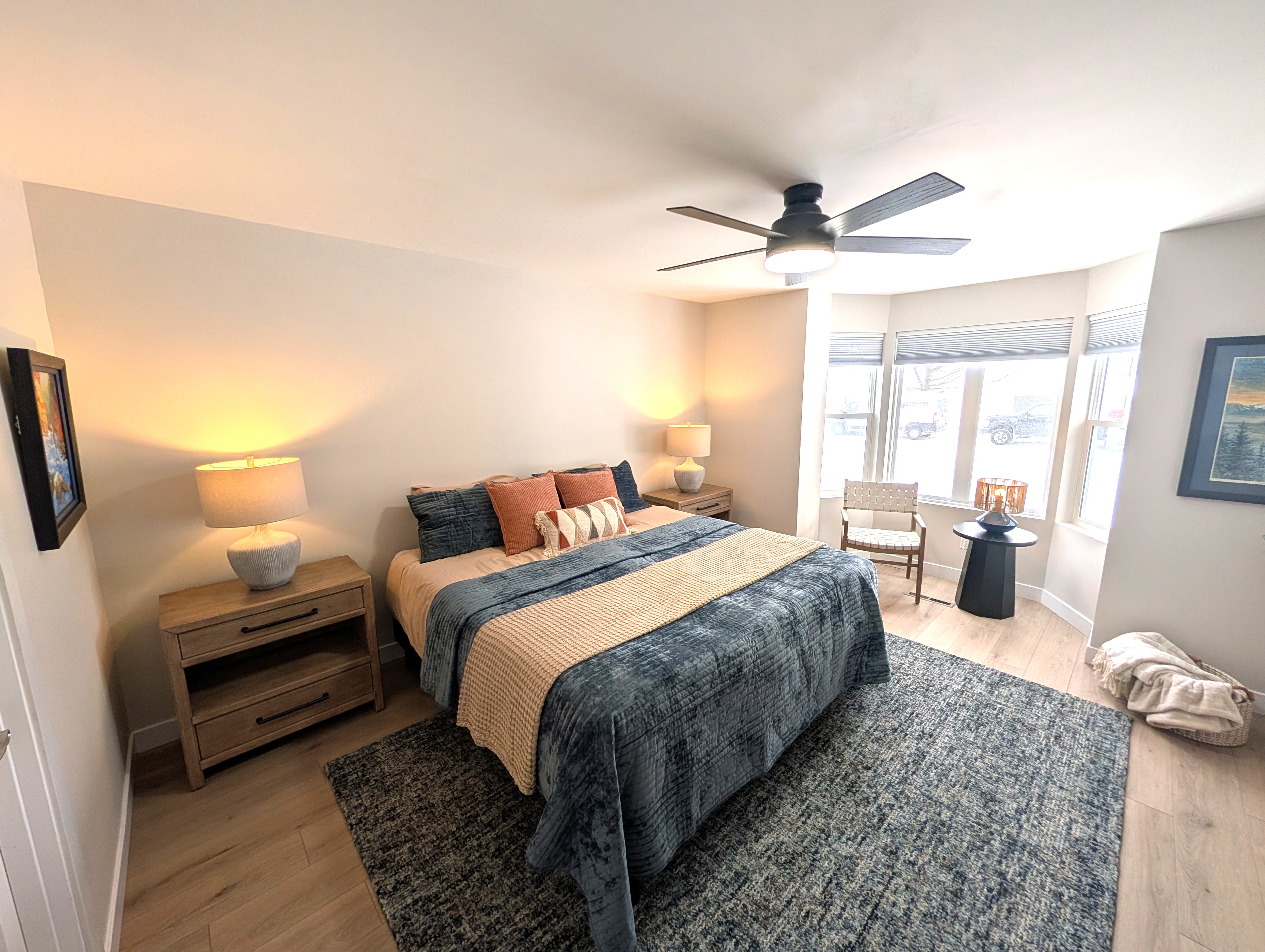 BEDROOM #1 (PRIMARY BEDROOM, MAIN FLOOR):  This is large and beautiful bed featuring a king-size bed, private ensuite full bathroom, private television, dresser, chair, ceiling fan, and closet.