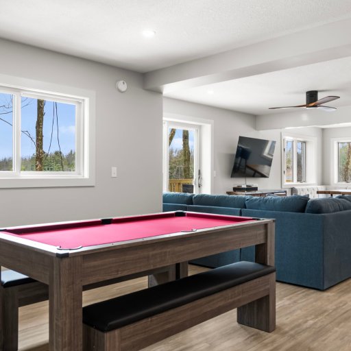 Full-size pool table with lake views through the windows
