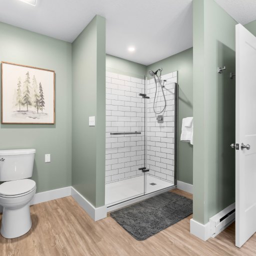 Walk-in tile shower with glass door in the en-suite bath