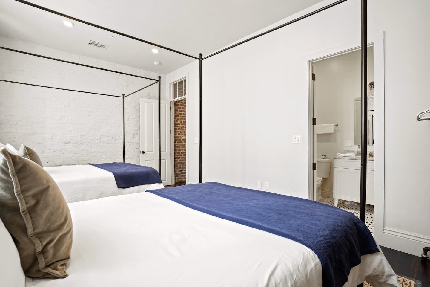 Master bedroom with two queen beds and an en suite bathroom