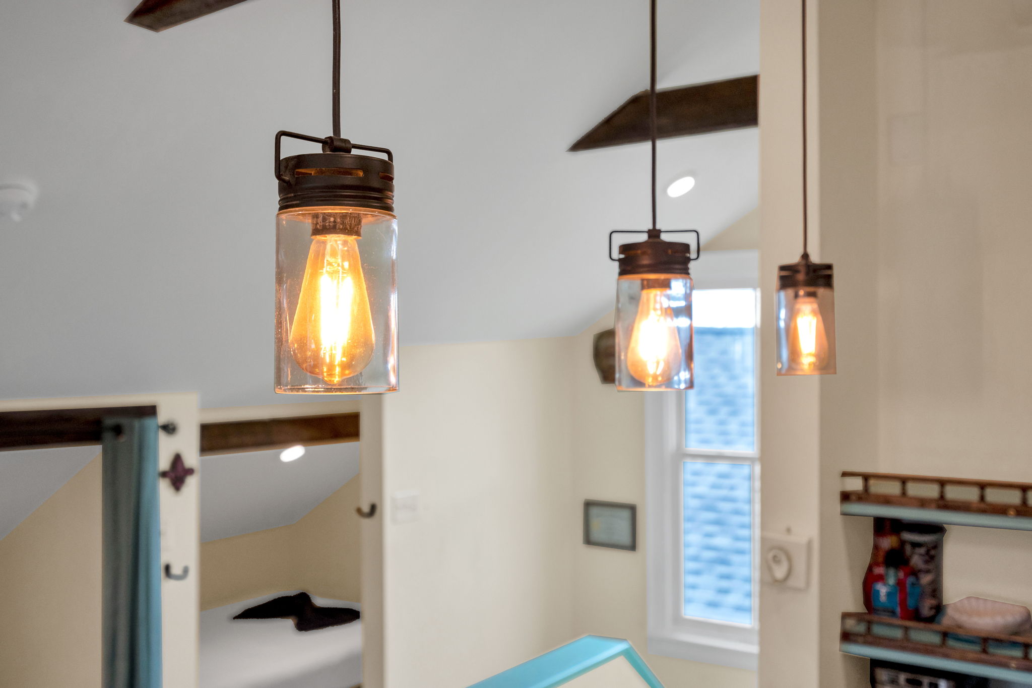 Charming industrial pendant lights add a modern Creole touch