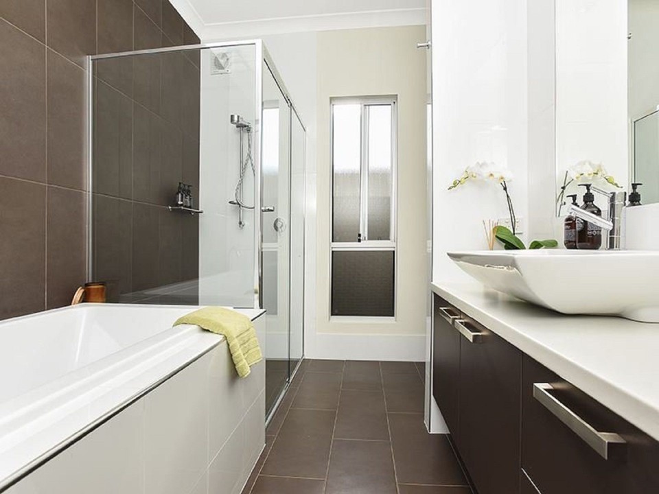 Premium Bathrooms. Ensuite with double vanities and rainfall shower, main bath with soaking tub and floor-to-ceiling tiles. Additional powder room/toilet for guests’ convenience