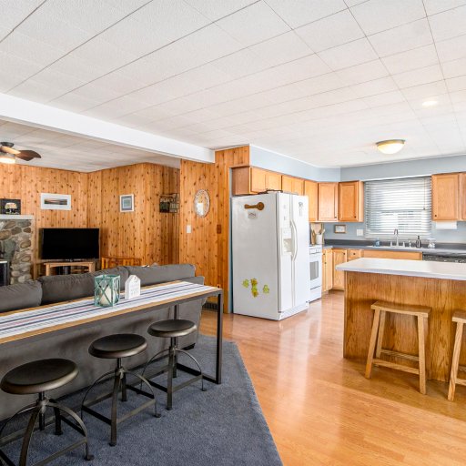 Open living and kitchen with a three-stool dining bar