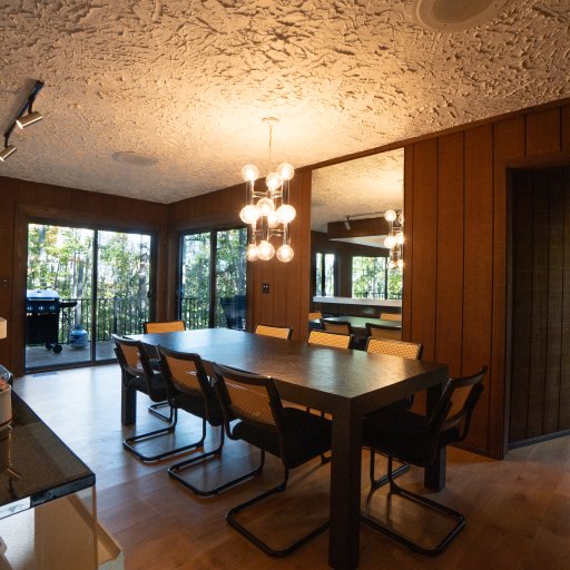 Open dining area with natural light and forest views