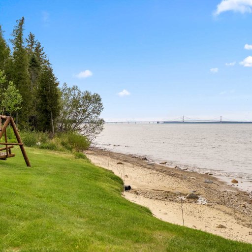 The Mackinac Bridge on the horizon from the shared beach and lawn swing