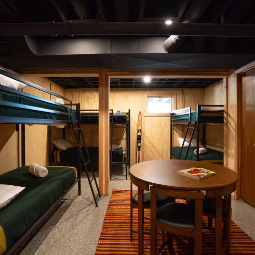 Bunk House — six twin beds in three bunks, with a card table