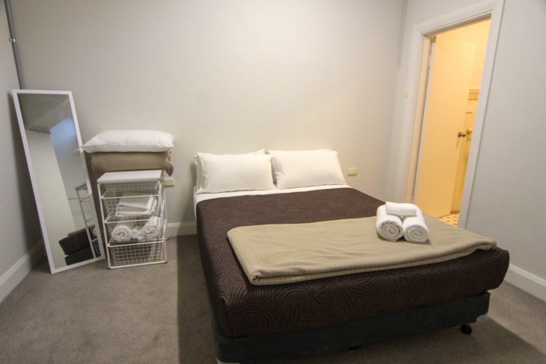 One spacious bedroom featuring a queen-sized bed, delivering comfort and privacy