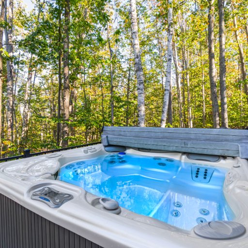 Private hot tub surrounded by forest for year-round relaxation