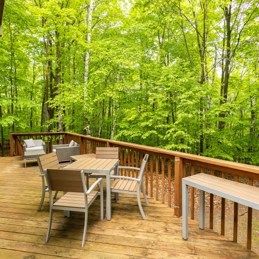 Relax on the spacious deck surrounded by lush greenery—perfect for outdoor dining, morning coffee, or evening cocktails