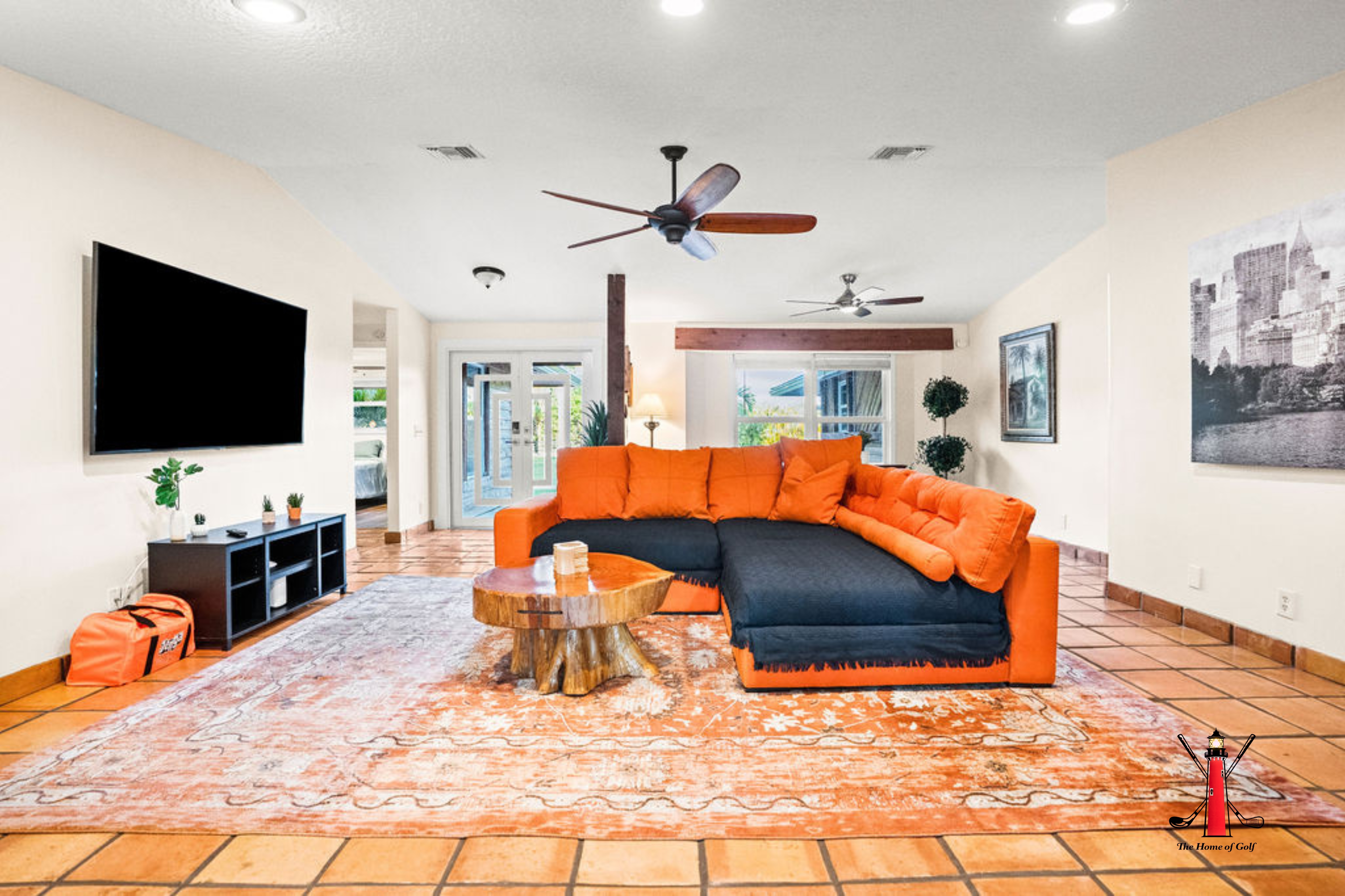 Spacious and inviting living room with a bold, modern touch! Enjoy a movie night on the big screen, or soak in the cozy atmosphere with comfortable seating and stylish decor.