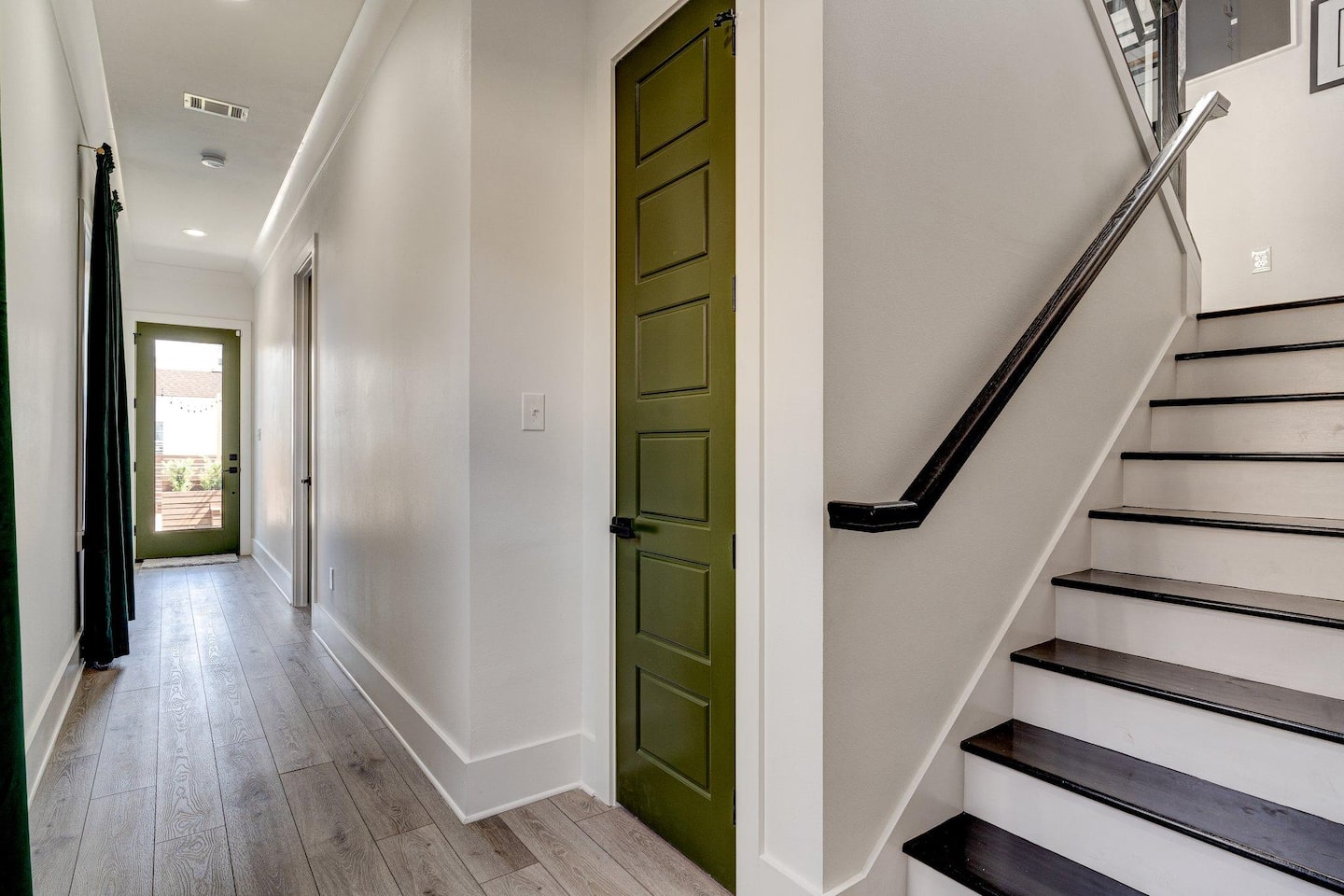 Behind the kitchen in a hallway leading to the stairs, the half bathroom under the stairs, and the down stairs master bedroom with attached bathroom - and of course the backyard! Let's stay inside for now though.