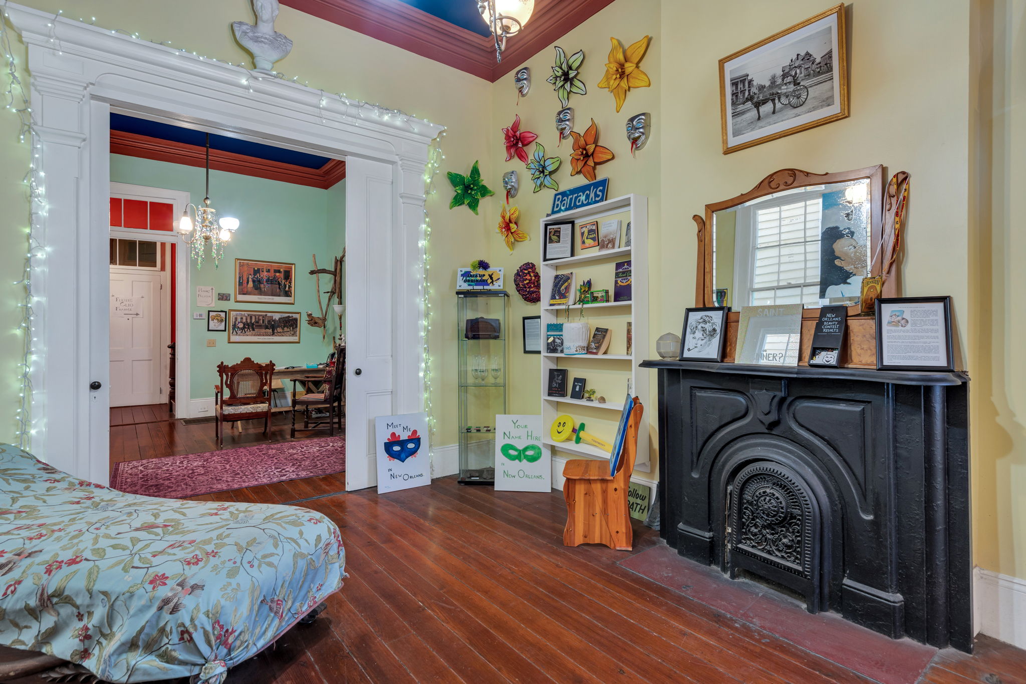 Unique, colorful room featuring an original fireplace, vintage details, and hardwood floors.