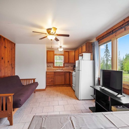Simple, open layout ideal for downtime after a beach day — includes TV, full kitchen, and space to gather