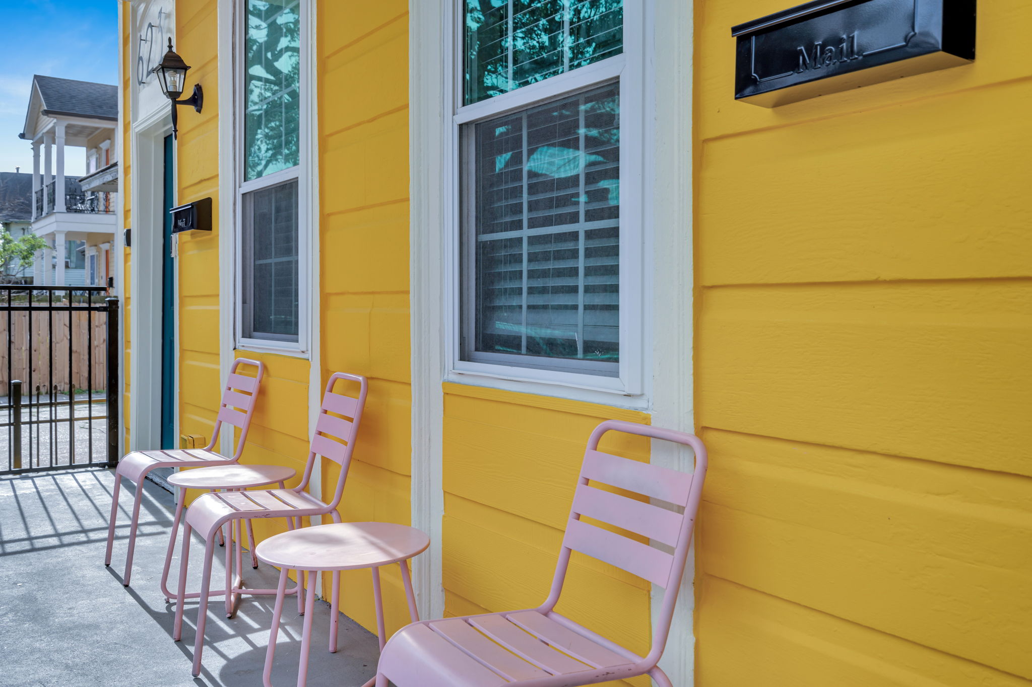 Sunny porch seating with classic New Orleans charm