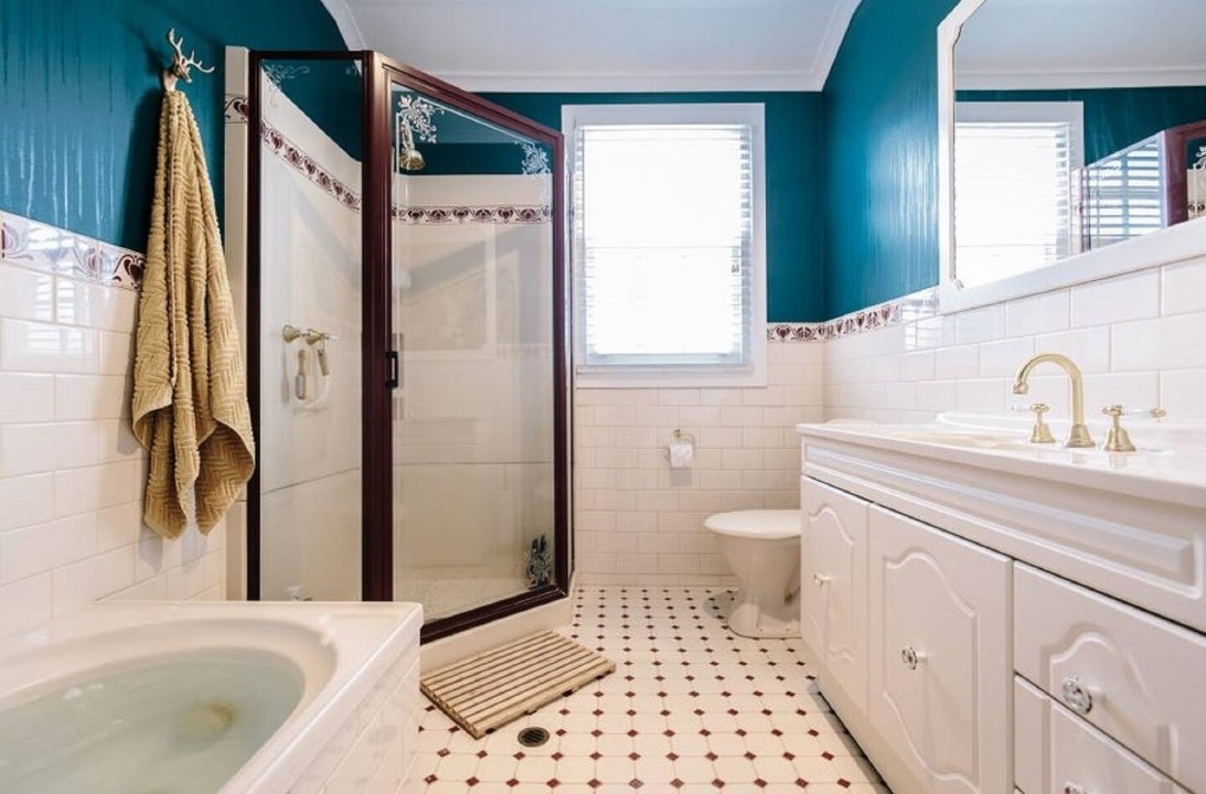 This bathroom is another highlight, featuring a shower, vanity, toilet and a large bath with spa jets