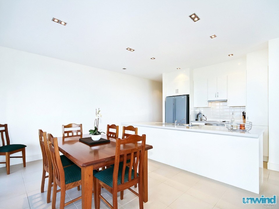 Equipped with a full kitchen, essential appliances, and spacious dining/living areas.