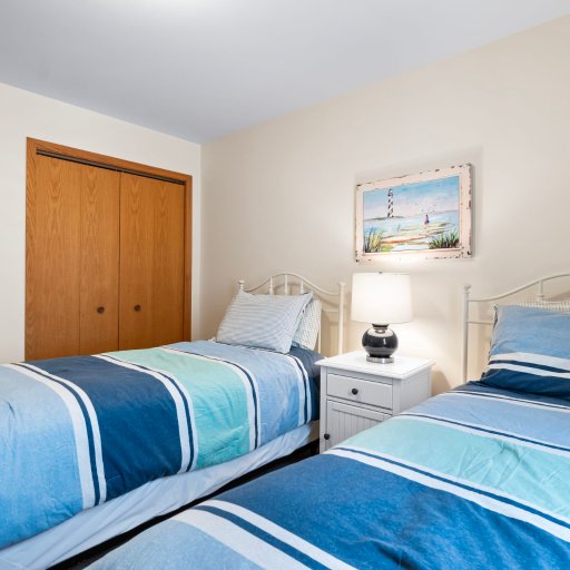 Bedroom 3: two twin beds with closet and nightstand.
