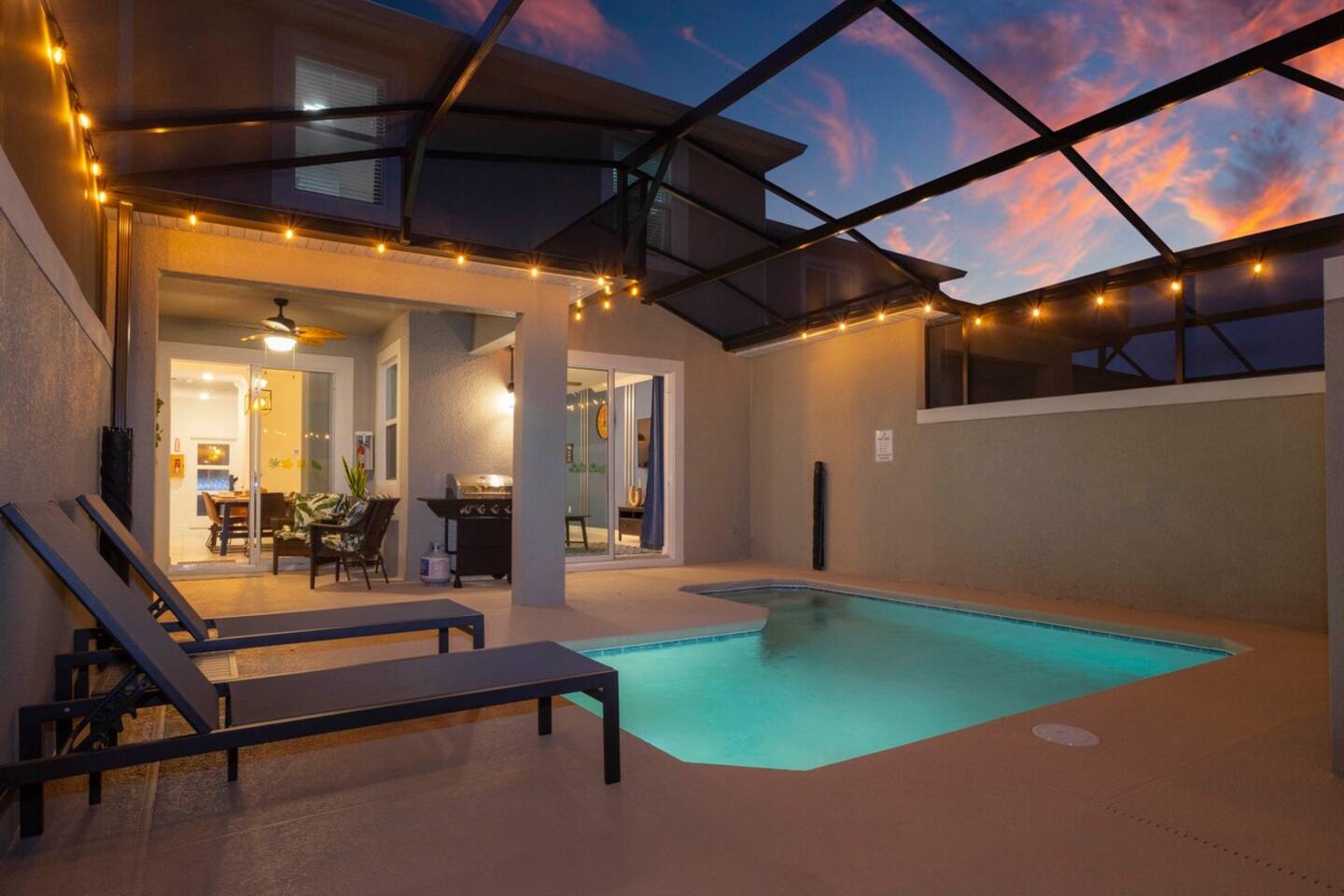 Enjoy a screened private pool with a BBQ grill and comfortable outdoor furniture, perfect for relaxing and dining al fresco.
