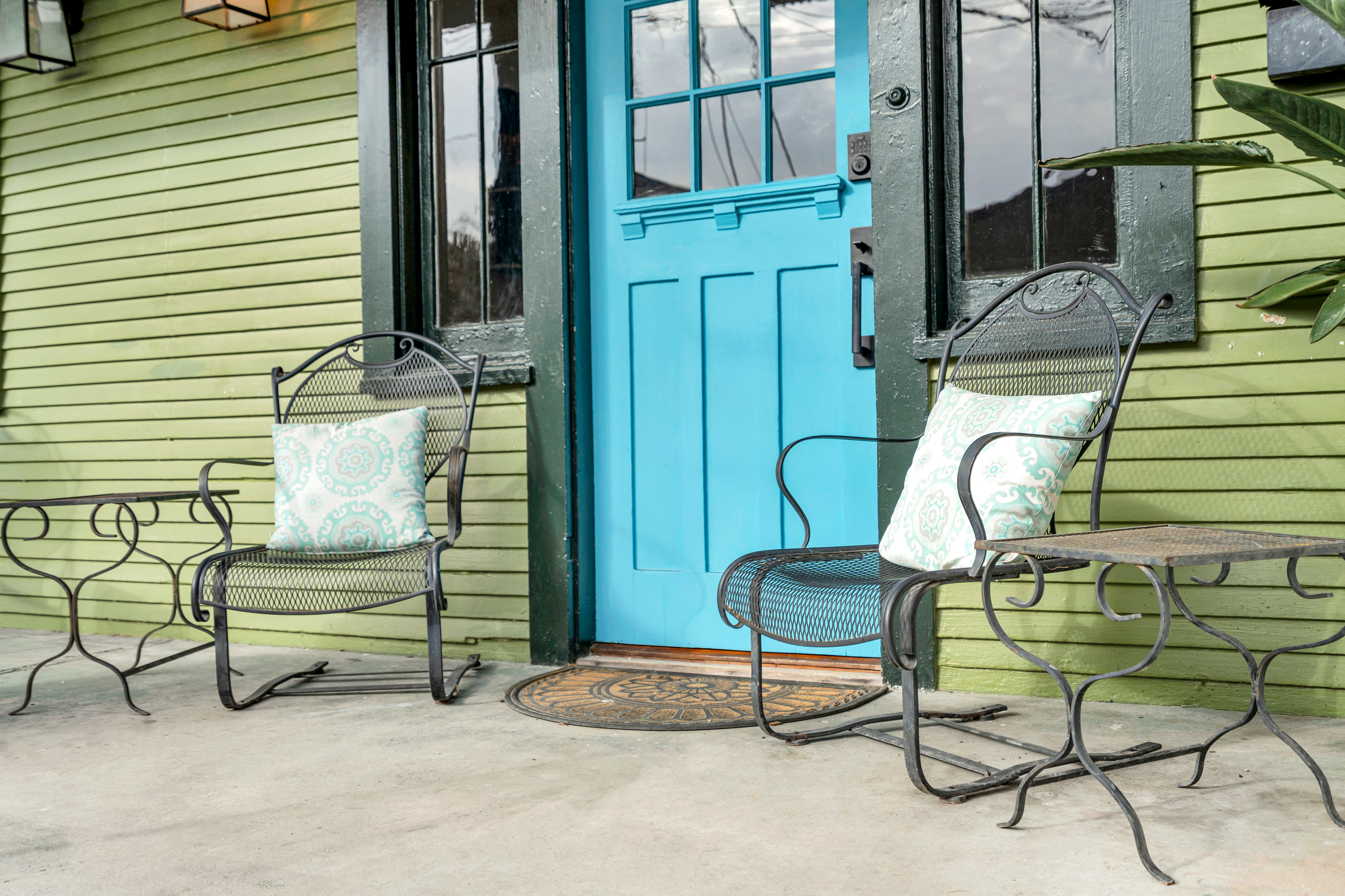 Private patio seating with blue entry door