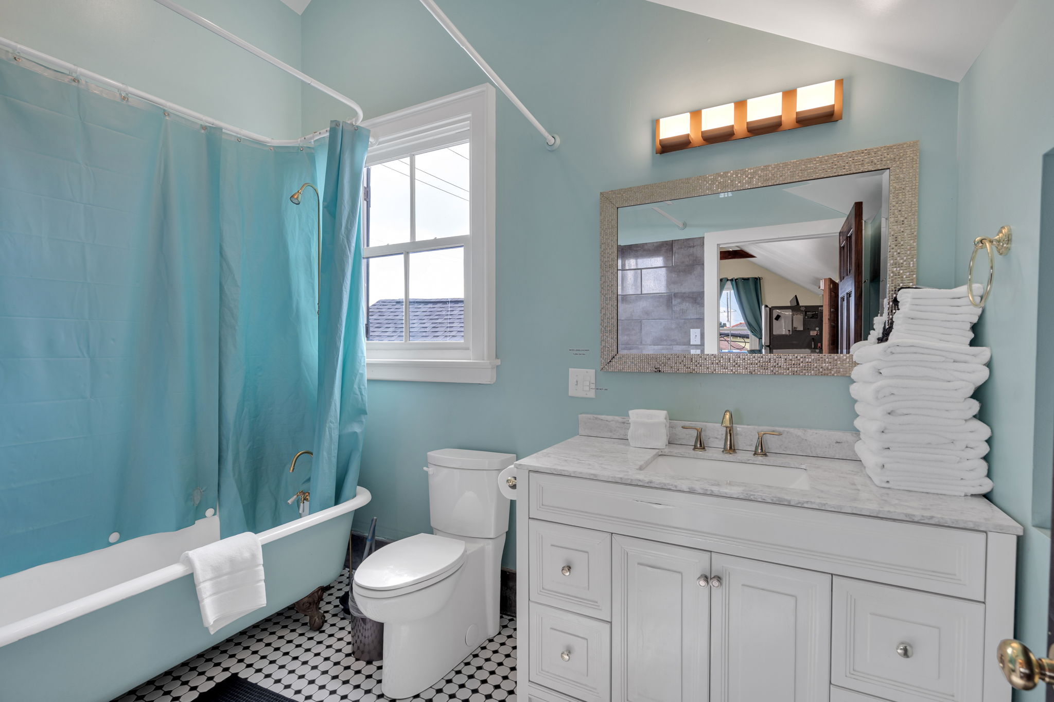 Full bathroom with double vanity and calming blue tones.