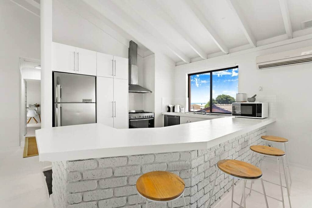 Well laid out kitchen, entertainer bench and breakfast bar. Ocean views from the sink.