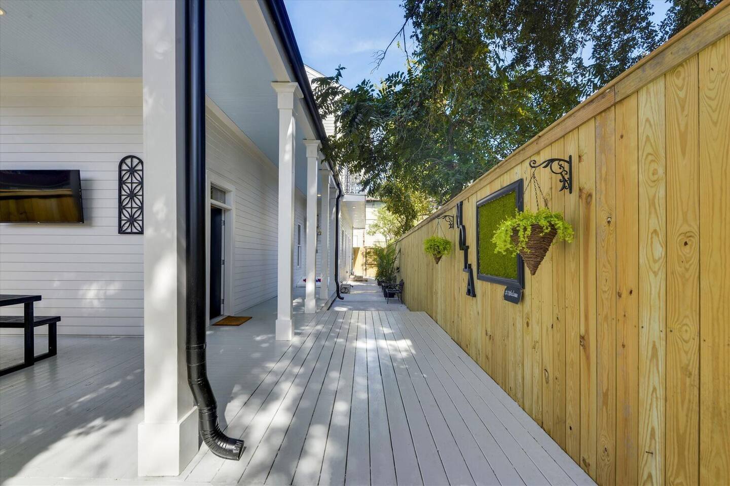 Charming side porch with NOLA touches and room to relax outdoors.