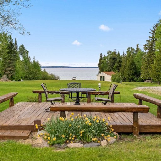Lakeside deck at the water's edge — table seating for four and log benches